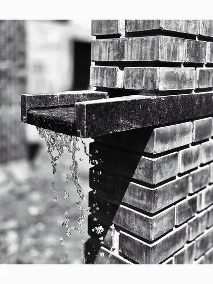 A close-up of a water spout detail at the Mandala Experience Center. This image highlights our focus on craftsmanship and the integration of functional elements, like gutters, into the architectural expression of the building.