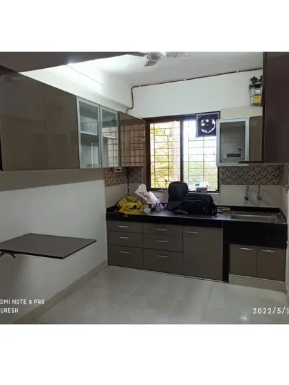In this Kandivali kitchen, I installed a compact, wall-mounted breakfast table. It provides a convenient spot for a quick meal without taking up permanent space in the kitchen layout.