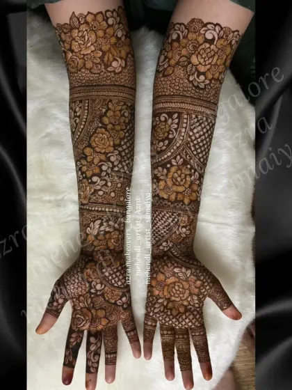 This design features prominent floral bands on the forearms, combined with detailed work on the hands.