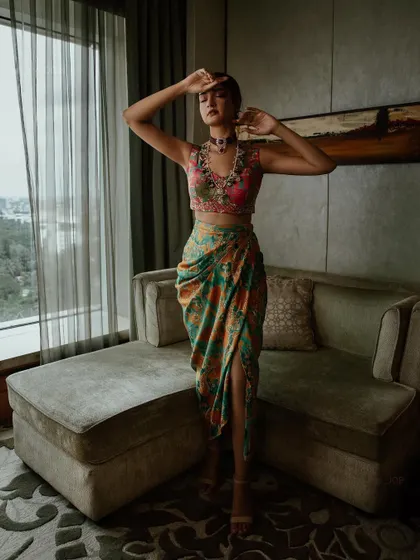 A standing shot of Shanvi Srivastava, showcasing how the draped skirt moves. This is a great example of an outfit that is both photogenic and comfortable for an event.