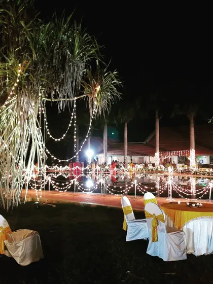 I use fairy lights to transform natural elements, like wrapping them around trees and bushes for this outdoor wedding. This creates a magical, sparkling effect throughout the venue at night.