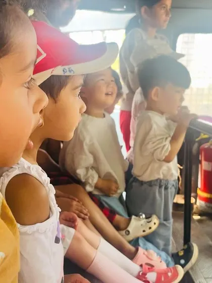 The children's excited faces as they get to sit inside the fire truck, a highlight of the trip.