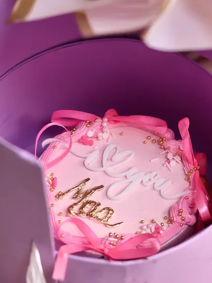 The surprise revealed. The hidden drawer contains a beautifully decorated 'I Love You Maa' bento cake.