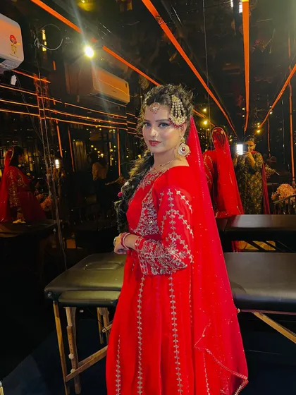 A full-length portrait that captures the grandeur of the Pakistani bridal attire. The bride stands confidently, her makeup and styling perfectly harmonized to create a powerful and elegant statement.