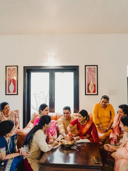 An intimate family gathering during a pre-wedding ritual, filled with conversation and laughter.