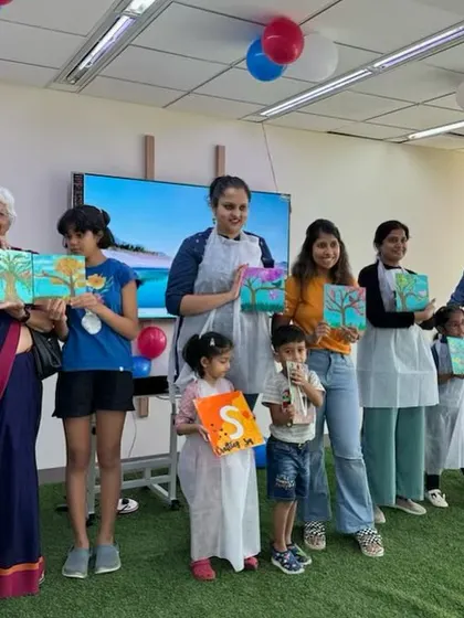 The whole group from our 'Palette Harmony' workshop posing with their beautiful tree paintings. It's a gallery of creativity from artists of all ages!