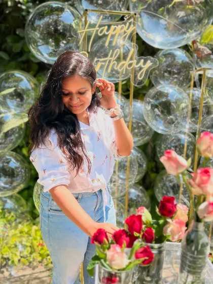 The bubble backdrop is a favorite for photoshoots. Here, our founder adds the finishing touches to the floral arrangements.