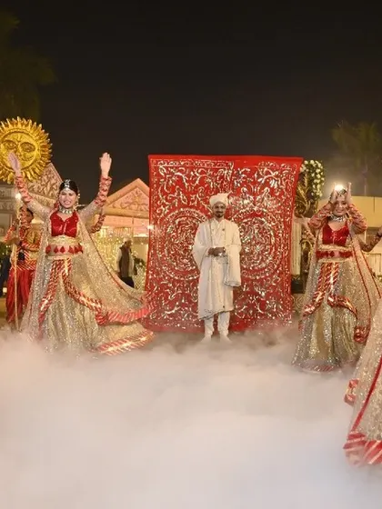 An amazing and jaw-dropping groom entry. Dancers in shimmering traditional attire perform amidst a cloud of smoke, their movements synchronized to create a path for the groom.