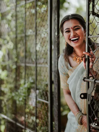 A moment of pure, uninhibited laughter from the bride, a perfect candid shot that captures her personality.