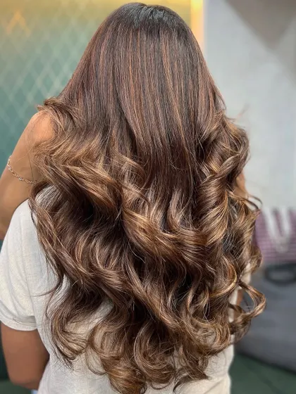 A beautiful blend of rich cocoa swirls and golden sun-kissed vibes. This style is perfect for adding warmth and dimension to long hair, finished with soft curls.