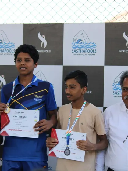 Winners of another swimming category posing with their medals and certificates.