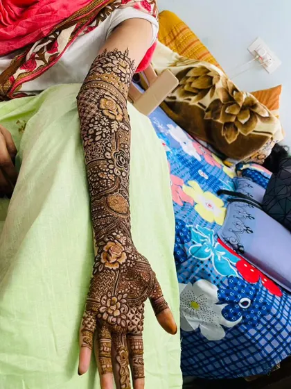 A full-sleeve floral design, meticulously applied to create a seamless pattern from wrist to elbow.