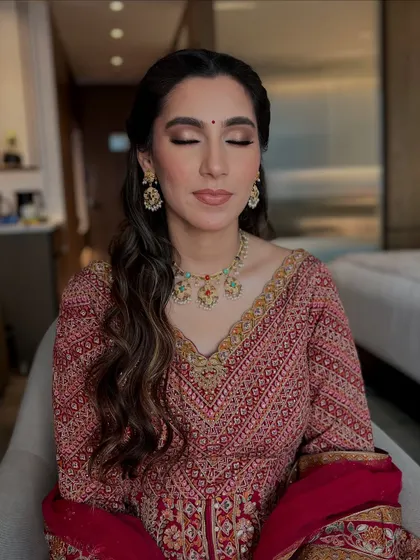 Another unfiltered shot with her eyes closed. You can see the soft eyeshadow and how the makeup sits on real skin.
