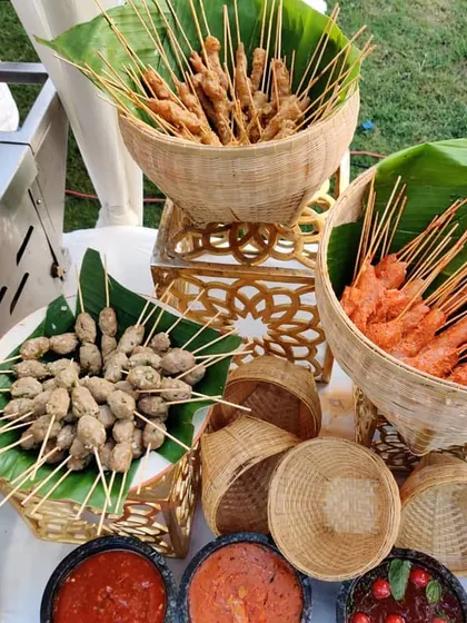 A live satay and grill station, perfect for outdoor events. We offer a variety of skewers, including chicken, mutton, and vegetarian options, served in traditional wicker baskets with authentic dipping sauces.
