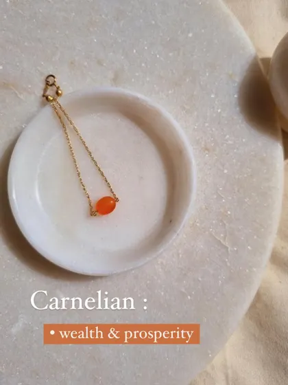 A close-up of my 'yíka' Carnelian oval bracelet, a stone that manifests prosperity, good luck, and light.