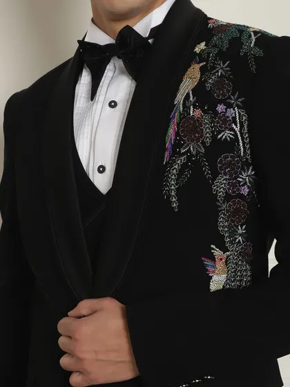 A detailed shot of the stunning, colorful bird and floral embroidery on our designer tuxedo jacket.