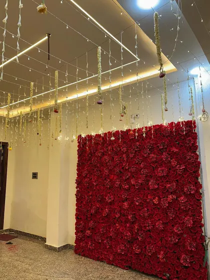 A close-up of the red rose flower wall inside the wedding house. This makes for a perfect, Instagram-worthy photo backdrop for guests.