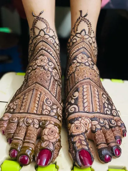 My bridal services include detailed and elegant mehendi for feet, ensuring you are adorned from head to toe. This design features intricate floral and architectural patterns covering the entire foot.