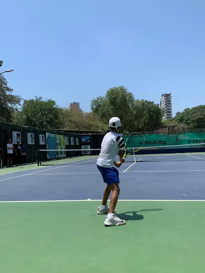 A player getting ready for a backhand shot during a competitive match in our junior tournament series.