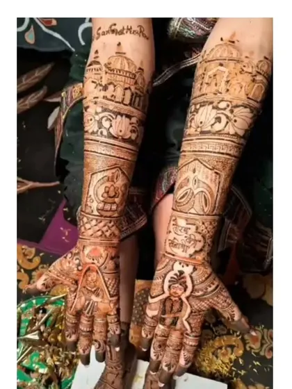 This design features portraits of the bride and groom on the palms, with symbols of their faith and journey, like the Golden Temple, on the forearms.