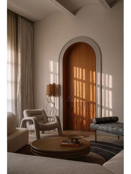 The salon area of the daughter's bedroom at Rehethaan, featuring a playful mix of furniture and a custom wooden screen that creates intriguing vignettes.