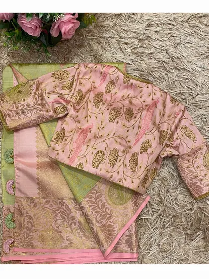 Another view of the pink blouse with bird motifs, laid out to showcase the beautiful embroidery work on the back.