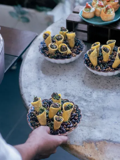 An example of our creative canapés. These savory cones are easy for guests to enjoy while mingling and showcase our kitchen's innovative approach to event catering.