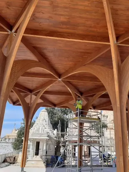The construction of modern timber pavilions at the historic temple site in Palitana, Gujarat. These structures provide shaded gathering spaces for pilgrims, and their innovative wooden forms create a contemporary dialogue with the ancient stone temples.