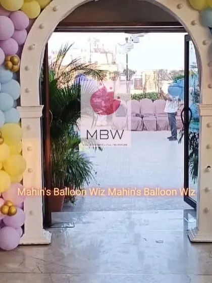 The grand entrance to the Bluey party, featuring a custom-built arch decorated with matching pastel balloons.