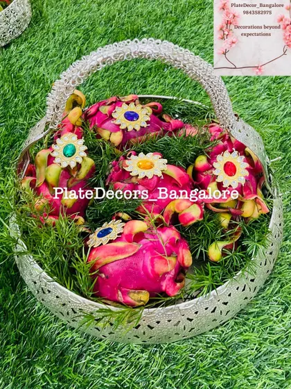 A beautiful silver basket filled with decorated dragon fruits. This is a great way to present exotic fruits as part of the seer varisai.