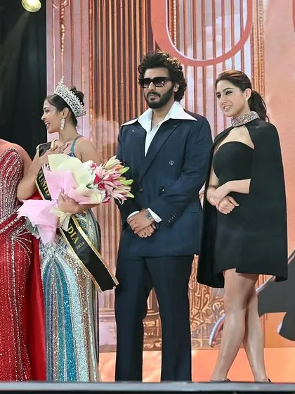 The winner receiving her bouquet on stage. These event photos document the journey and success of a model in the competitive world of pageantry.