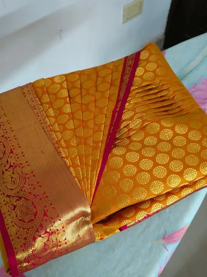 The crisp, even pleats of this yellow saree are a testament to my professional technique. My service ensures you get this perfect look every time.