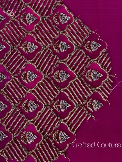 This image displays the rich, textured embroidery pattern on a blouse, a piece of crafted couture that combines traditional techniques with a modern aesthetic.