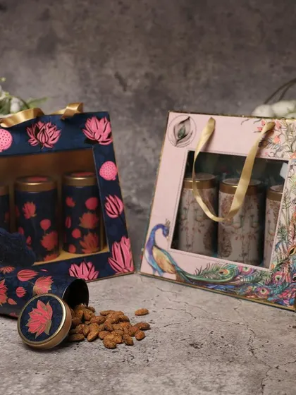 A set of two dry fruit boxes with peacock and floral designs. These are perfect for sending festive wishes to family and friends.