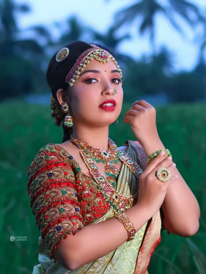 A close-up shot that captures the intensity and beauty of the bridal look. The nose ring and maang tikka are key elements of this traditional style.