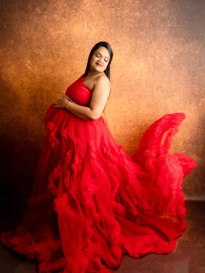 Capturing the flow and movement of this stunning red gown. I use fabric tossing techniques to create a sense of dynamic energy in the portrait.