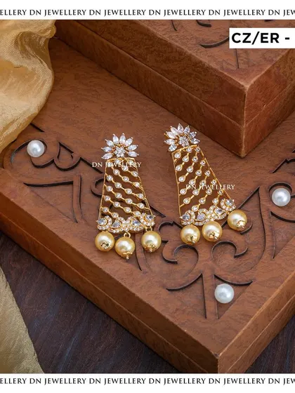 These unique triangular-shaped earrings with pearl drops are a modern and stylish choice. They are perfect for a cocktail party or a contemporary look.