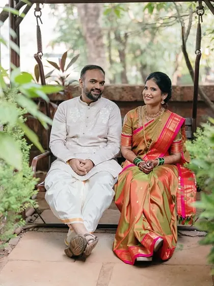 A serene moment shared on a swing, surrounded by greenery. The couple's traditional attire adds a touch of elegance to the natural setting.