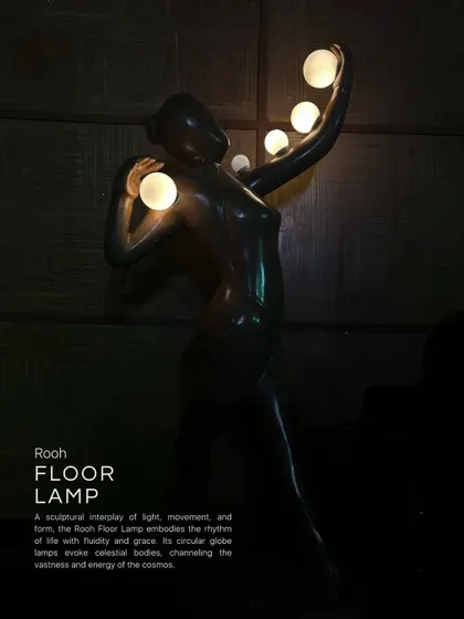The Rooh Floor Lamp is a sculptural interplay of light, movement, and form. The figure embodies the rhythms of life with grace, while its circular glass lamps evoke celestial bodies, channeling the vastness and energy of the cosmos.