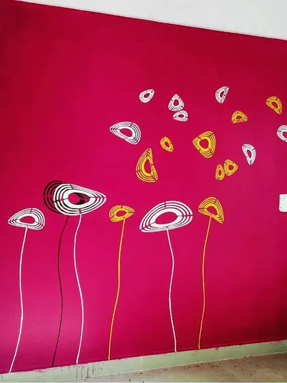 A playful abstract floral mural on a bright magenta wall. This design uses simple lines and shapes to create a modern and cheerful atmosphere.