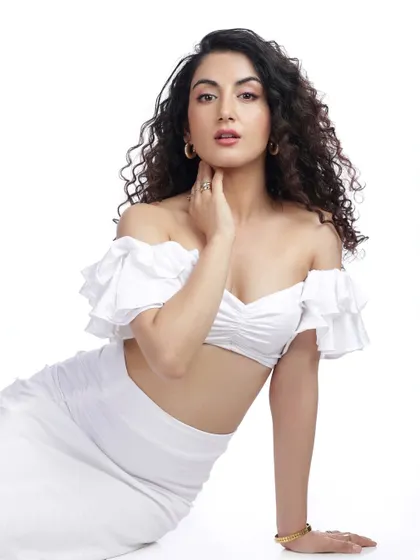 A classic beauty pose, with the model's hand gently touching her neck. The clean white background and simple styling highlight her natural elegance.