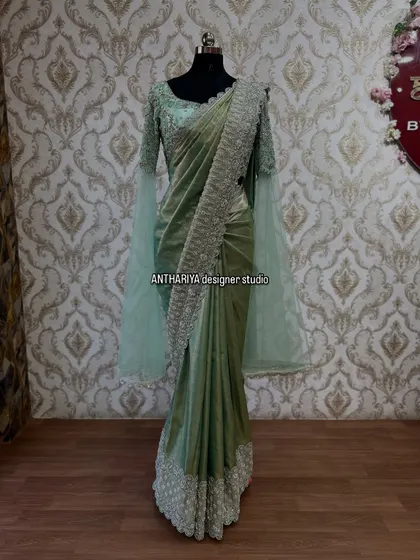 The full view of the pastel green saree gown, perfect for a cocktail party or reception.
