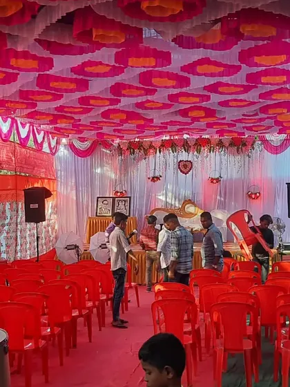 A pandal setup for an engagement event, with the stage and seating ready before the function begins.
