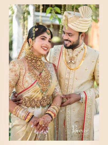 A classic portrait of the bride and groom. Her makeup is timeless, with a focus on flawless skin and defined eyes that complement his traditional attire.