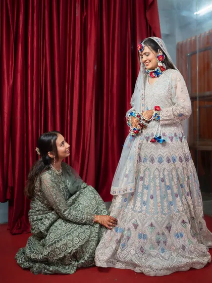A sweet moment between the bride and her bridesmaid. These candid interactions add a layer of warmth and personality to the wedding album.
