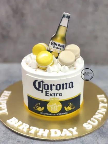 A fun Corona beer cake. This cake is designed to look just like a Corona can, topped with macarons for a sweet twist.