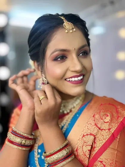 Another angle showing the makeup and jewellery in detail.