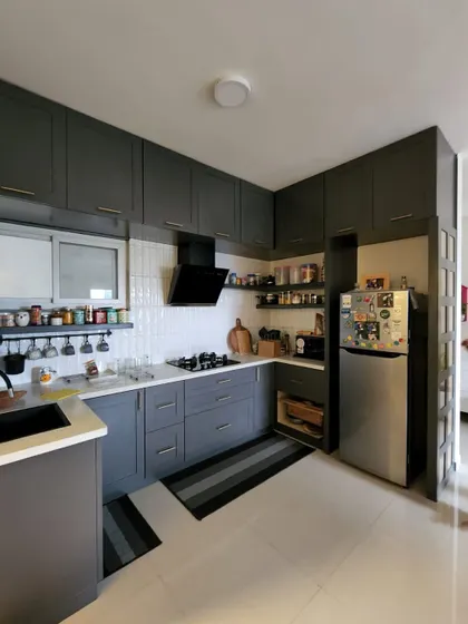 This kitchen is so smooth, even my cooking disasters might start looking gourmet. A modern, moody grey kitchen with open spice racks and a clean, organized feel.