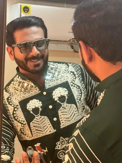 A close-up of my custom green kurta for a Navratri night. The detailed embroidery and unique patterns ensure I look the part for the grand celebration.