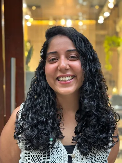 I had so much fun styling this real-life Moana. Her beautiful, long curls are accessorized with flowers and clips, showing how versatile curly hair can be.